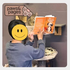 Children sitting together with books during a Paws & Pages reading session