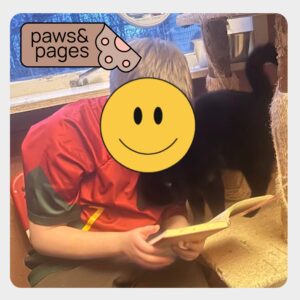 Child reading quietly during a Paws & Pages session