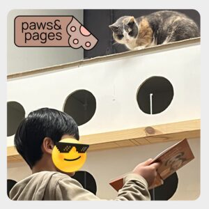 Child reading while a calm animal rests nearby