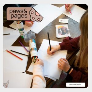 Child drawing and working quietly during a Paws & Pages session