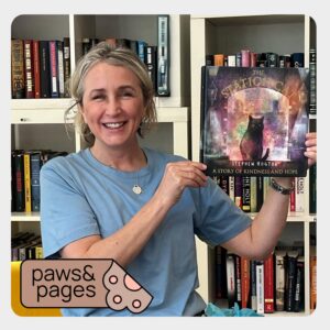 Adult holding up a book while introducing a reading activity